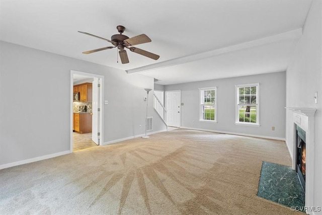 12628 Copperas Ln, Richmond, VA 23233 - unfurnished living room featuring light carpet, a fireplace with flush hearth, a ceiling fan, stairs, and beamed ceiling