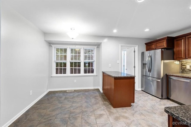 12628 Copperas Ln, Richmond, VA 23233 - kitchen with appliances with stainless steel finishes, dark stone counters, decorative backsplash, recessed lighting, and light stone finish floors