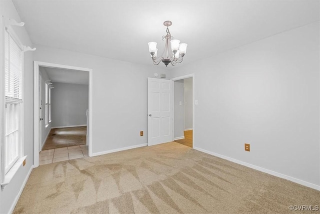 12628 Copperas Ln, Richmond, VA 23233 - tiled empty room featuring a chandelier, carpet, and plenty of natural light