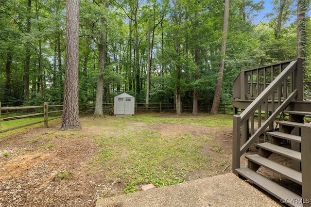 12628 Copperas Ln, Richmond, VA 23233 - fenced backyard with stairs, a storage shed, and a deck