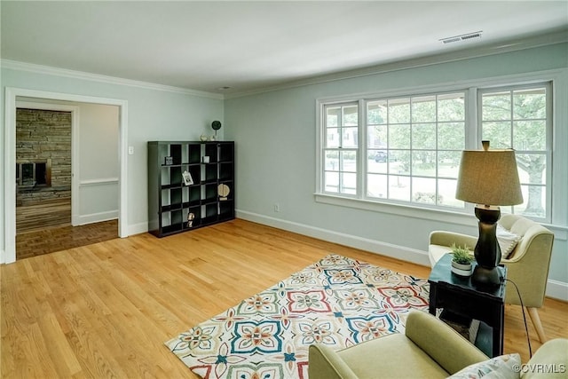 10070 Rinker Dr, Mechanicsville, VA 23116 - sitting room featuring healthy amount of natural light, ornamental molding, a fireplace, and wood finished floors
