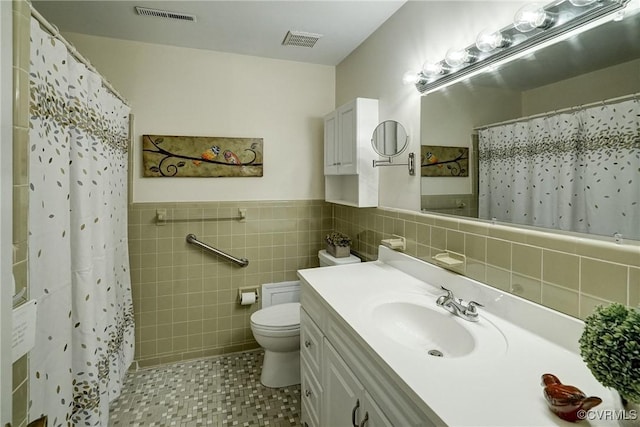 10070 Rinker Dr, Mechanicsville, VA 23116 - bathroom featuring tile walls, vanity, a shower with shower curtain, tile patterned floors, and a wainscoted wall
