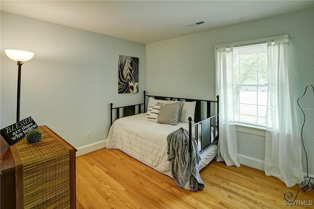 10070 Rinker Dr, Mechanicsville, VA 23116 - bedroom featuring light wood-style flooring and multiple windows