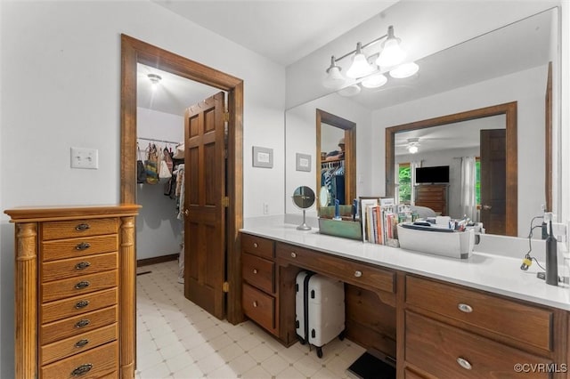 124 Gammons Vw, Bumpass, VA 23024 - bathroom featuring tile patterned floors, ceiling fan, a walk in closet, and vanity