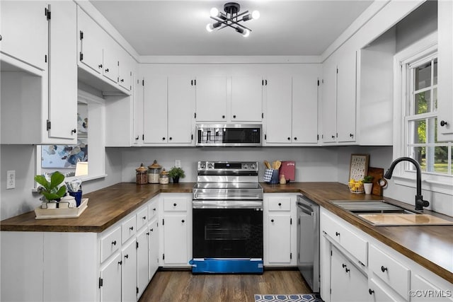 2505 Winston Ct, Glen Allen, VA 23060 - kitchen featuring stainless steel appliances, dark countertops, white cabinetry, and dark wood-style flooring