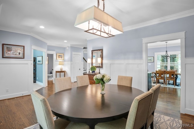2432 Gammons Creek Dr, Maidens, VA 23102 - dining space with a chandelier, ornamental molding, wood finished floors, a decorative wall, and wainscoting