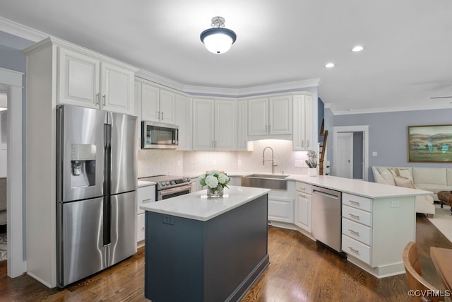 2432 Gammons Creek Dr, Maidens, VA 23102 - kitchen featuring stainless steel appliances, a peninsula, light countertops, crown molding, and white cabinets