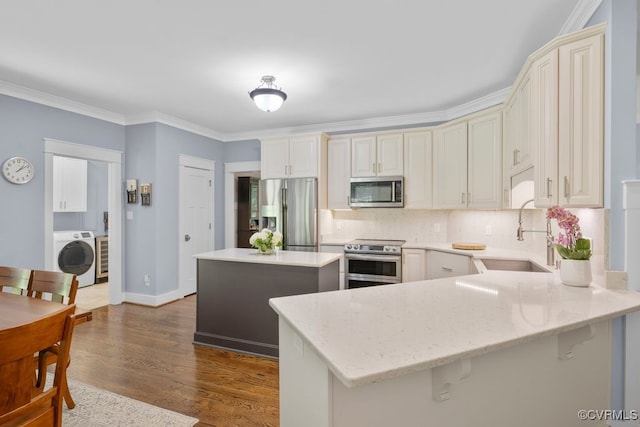2432 Gammons Creek Dr, Maidens, VA 23102 - kitchen featuring stainless steel appliances, washer / dryer, a peninsula, decorative backsplash, and light stone countertops