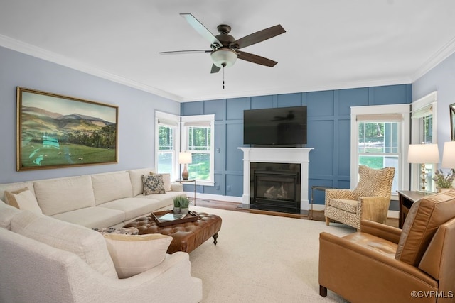 2432 Gammons Creek Dr, Maidens, VA 23102 - living area featuring ornamental molding, a decorative wall, a ceiling fan, a glass covered fireplace, and wood finished floors