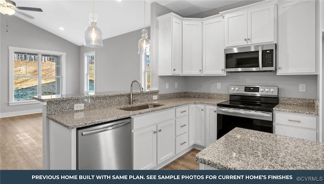 447 Raleigh Ave, South Hill, VA 23970 - kitchen featuring appliances with stainless steel finishes, light wood-type flooring, white cabinets, a peninsula, and a ceiling fan