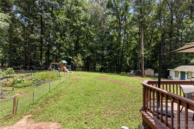 2708 Pineridge Ln, Powhatan, VA 23139 - view of grassy yard featuring a playground, a storage unit, and a deck