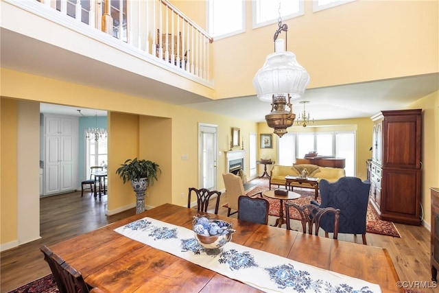 10966 Bland Ridge Dr, South Prince George, VA 23805 - dining space featuring a chandelier, plenty of natural light, a towering ceiling, and wood finished floors