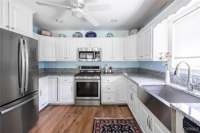 10966 Bland Ridge Dr, South Prince George, VA 23805 - kitchen featuring appliances with stainless steel finishes, white cabinetry, a ceiling fan, and dark wood-type flooring