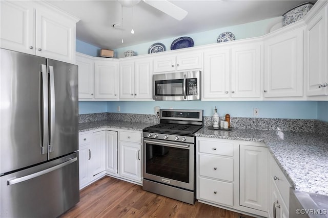 10966 Bland Ridge Dr, South Prince George, VA 23805 - kitchen featuring appliances with stainless steel finishes, white cabinets, a ceiling fan, dark wood-type flooring, and light stone counters