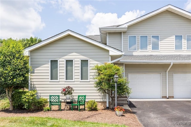 10966 Bland Ridge Dr, South Prince George, VA 23805 - view of front facade featuring roof with shingles, a garage, and asphalt driveway