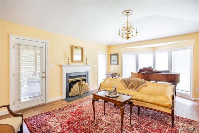 10966 Bland Ridge Dr, South Prince George, VA 23805 - living room with a fireplace with flush hearth, wood finished floors, and a chandelier