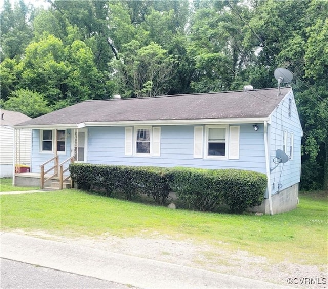 422 Walnut St, Petersburg, VA 23803 - view of front facade with a front lawn and roof with shingles