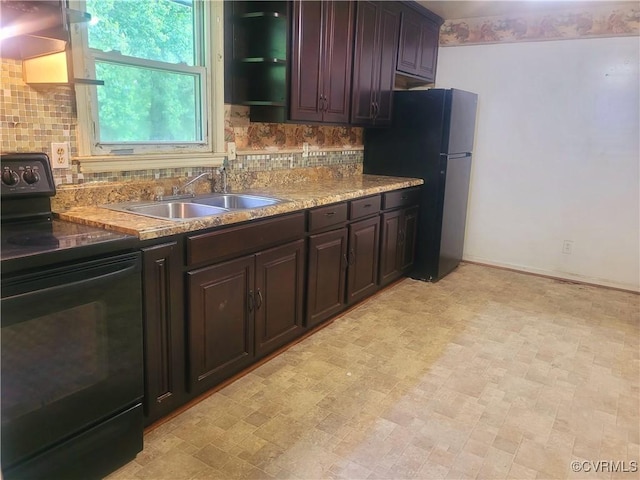 422 Walnut St, Petersburg, VA 23803 - kitchen with electric range, decorative backsplash, freestanding refrigerator, and dark brown cabinets