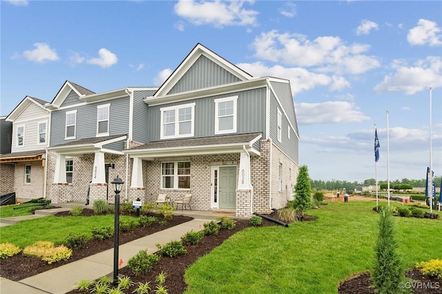 6009 Banyan Ln, Chesterfield, VA 23234 - view of front of home featuring board and batten siding, a front lawn, and brick siding