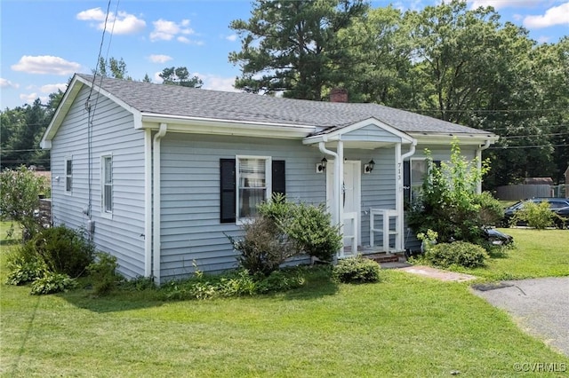 713 Lakeview Ave, Colonial Heights, VA 23834 - view of front of home with a front yard, a chimney, and roof with shingles