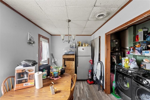 713 Lakeview Ave, Colonial Heights, VA 23834 - dining space with washing machine and clothes dryer, wood finished floors, crown molding, and water heater