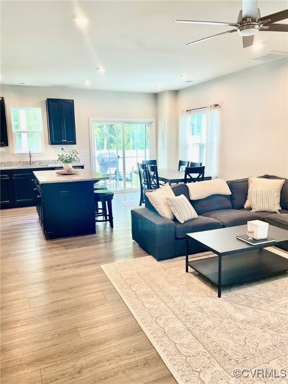 10904 Genito Square Dr, Chesterfield, VA 23112 - living area with plenty of natural light, a ceiling fan, and light wood-type flooring