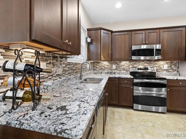 17318 Library Blvd, Ruther Glen, VA 22546 - kitchen featuring stainless steel appliances, light stone counters, tasteful backsplash, dark brown cabinetry, and recessed lighting