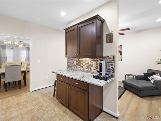 17318 Library Blvd, Ruther Glen, VA 22546 - kitchen with ceiling fan, tasteful backsplash, dark brown cabinets, light stone countertops, and recessed lighting
