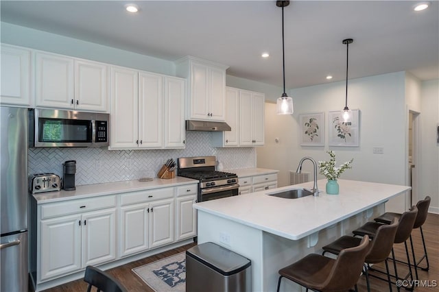 6448 Twin Falls Ter, Moseley, VA 23120 - kitchen with stainless steel appliances, under cabinet range hood, dark wood-type flooring, decorative backsplash, and white cabinets
