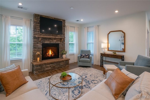 6448 Twin Falls Ter, Moseley, VA 23120 - living room featuring plenty of natural light, a fireplace, wood finished floors, and recessed lighting