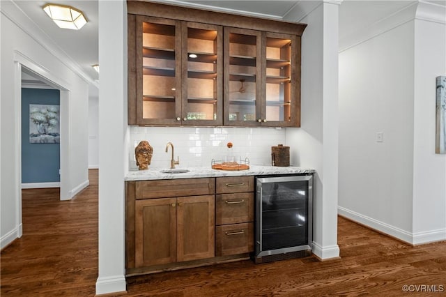 4705 Fitzhugh Ave, Richmond, VA 23230 - indoor wet bar featuring beverage cooler, dark wood finished floors, decorative backsplash, and crown molding