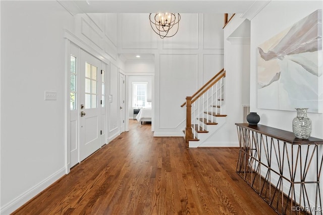 4705 Fitzhugh Ave, Richmond, VA 23230 - foyer entrance with wood finished floors, a chandelier, stairway, and a decorative wall