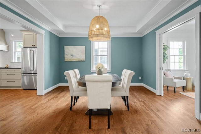 4705 Fitzhugh Ave, Richmond, VA 23230 - dining room featuring healthy amount of natural light, a raised ceiling, light wood-style flooring, and ornamental molding