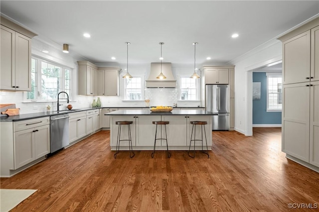 4705 Fitzhugh Ave, Richmond, VA 23230 - kitchen featuring stainless steel appliances, dark countertops, premium range hood, decorative backsplash, and crown molding