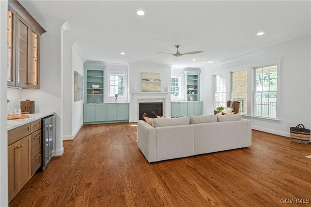 4705 Fitzhugh Ave, Richmond, VA 23230 - living room with crown molding, wood finished floors, a glass covered fireplace, a ceiling fan, and recessed lighting