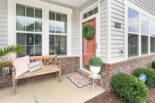 7828 Vermeil St, North Chesterfield, VA 23237 - doorway to property with covered porch and brick siding