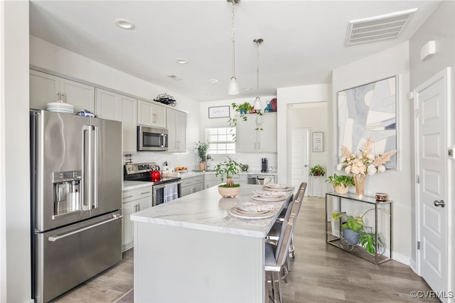 7828 Vermeil St, North Chesterfield, VA 23237 - kitchen with appliances with stainless steel finishes, a center island, light wood finished floors, backsplash, and recessed lighting