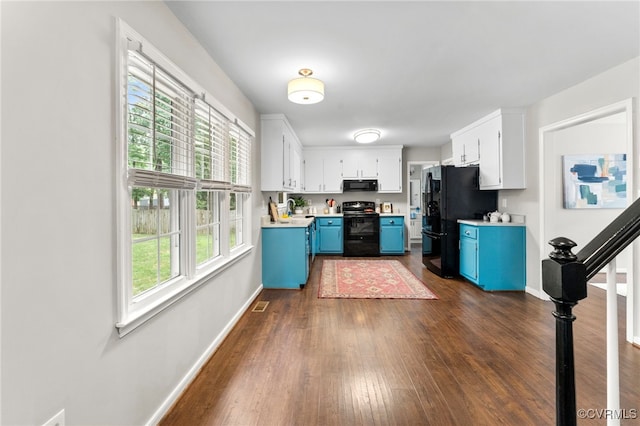 7707 Northern Dancer Ct, Midlothian, VA 23112 - kitchen featuring black appliances, blue cabinetry, dark wood-style floors, light countertops, and white cabinets