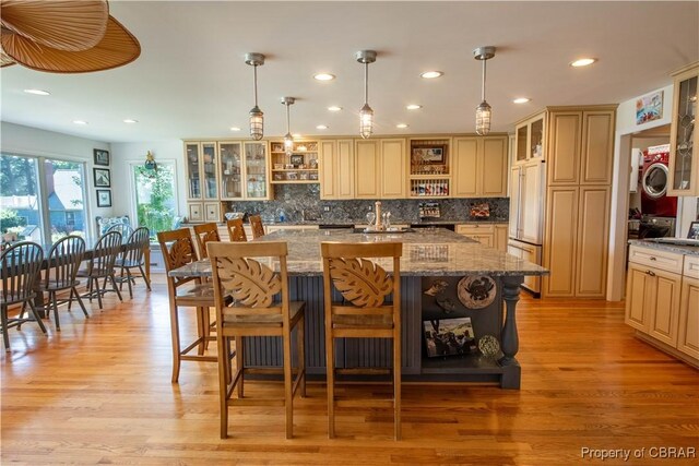 11 Franklin St, Deltaville, VA 23043 - kitchen featuring open shelves, recessed lighting, tasteful backsplash, paneled built in fridge, and a center island