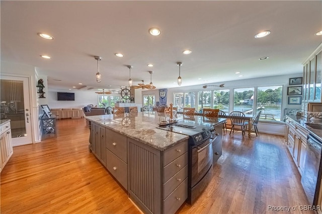 11 Franklin St, Deltaville, VA 23043 - kitchen featuring black range with electric cooktop, open floor plan, light wood-type flooring, recessed lighting, and stainless steel dishwasher