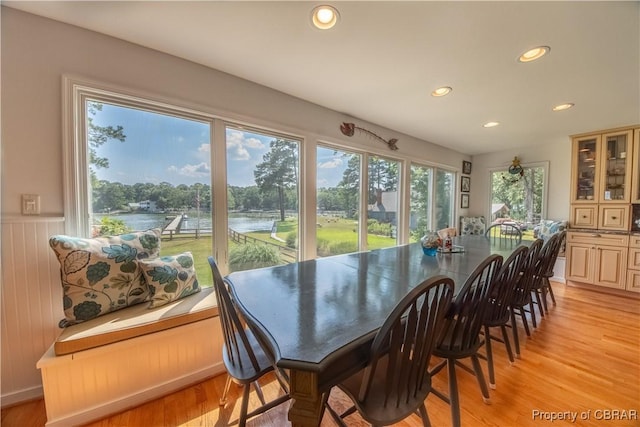11 Franklin St, Deltaville, VA 23043 - dining area with recessed lighting, light wood-style flooring, a wainscoted wall, and a water view