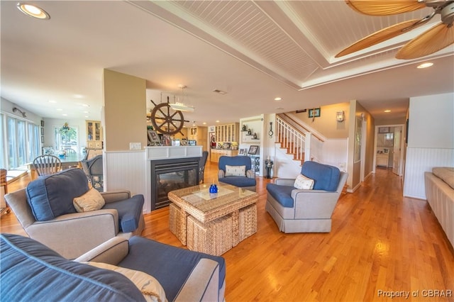 11 Franklin St, Deltaville, VA 23043 - living room featuring a wainscoted wall, stairs, light wood-style floors, a ceiling fan, and recessed lighting