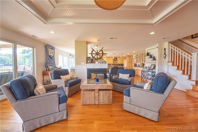 11 Franklin St, Deltaville, VA 23043 - living room with stairway, a multi sided fireplace, light wood-style floors, recessed lighting, and ornamental molding