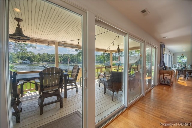 11 Franklin St, Deltaville, VA 23043 - doorway to outside featuring wood finished floors and a water view