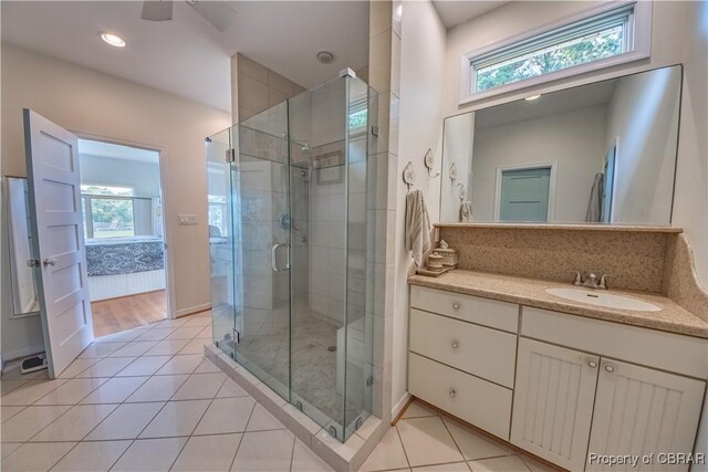 11 Franklin St, Deltaville, VA 23043 - full bath with a stall shower, plenty of natural light, vanity, tile patterned flooring, and recessed lighting