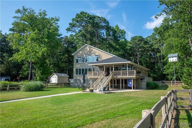 11 Franklin St, Deltaville, VA 23043 - rear view of house featuring stairway, a wooden deck, a shed, and view of wooded area