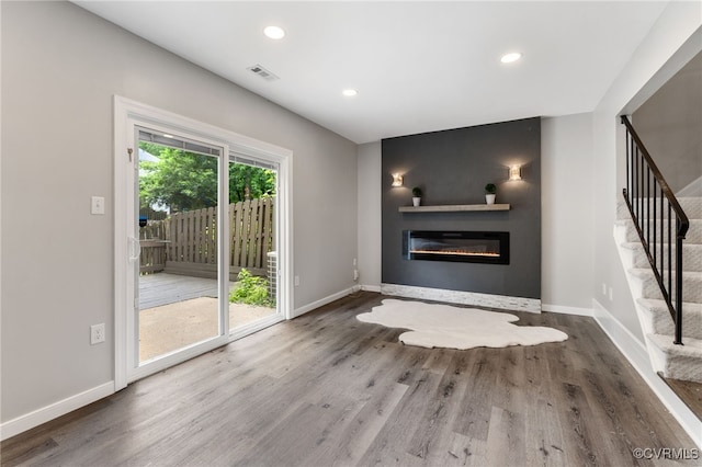 1553 United Ct, Henrico, VA 23238 - unfurnished living room featuring stairway, wood finished floors, a glass covered fireplace, and recessed lighting