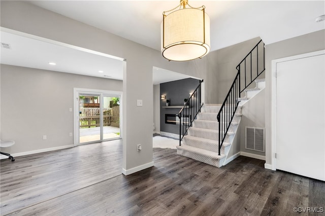 1553 United Ct, Henrico, VA 23238 - entryway with stairway, dark wood-style floors, a glass covered fireplace, and recessed lighting