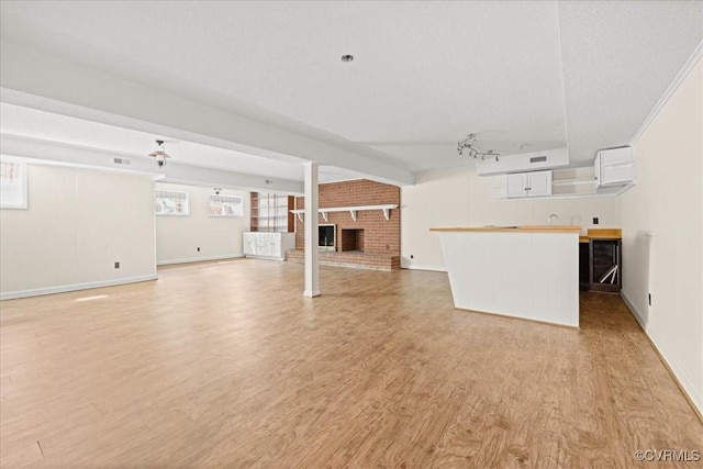 3000 W Riverside Ave, Hopewell, VA 23860 - unfurnished living room with light wood-type flooring and a fireplace