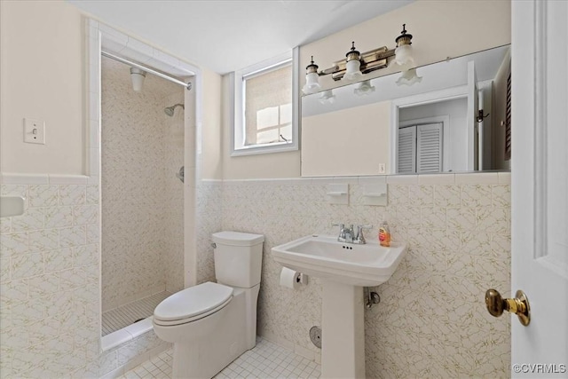 3000 W Riverside Ave, Hopewell, VA 23860 - bathroom with tile walls, a tile shower, tile patterned flooring, and wainscoting